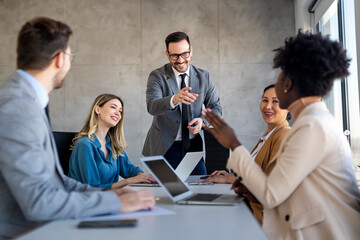 Group of young business people working as a team and communicating in corporate office
