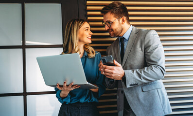 Busy smiling executive business team using digital devices in office. Diverse professional people