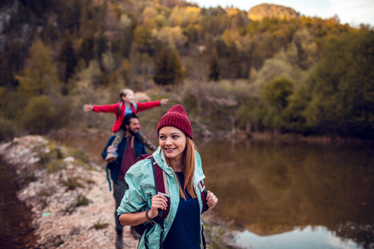 Family hiking together by a mountain lake