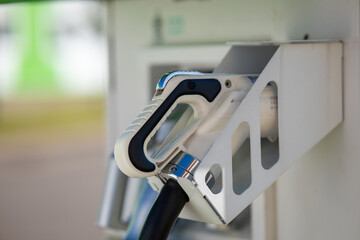 Electric car charging plug at a public station.