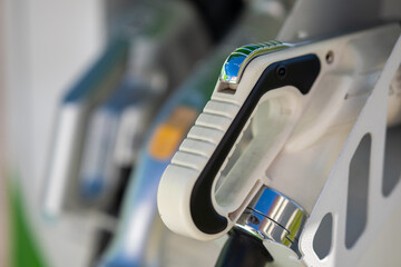 Electric car charger handle at a public station.