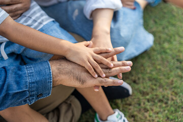 Happy asian family parents with a child smiling and playing in the public park happy together lawn at sunset picnic on weekend. Father mother with boy relationship in family sunlight summer vacation
