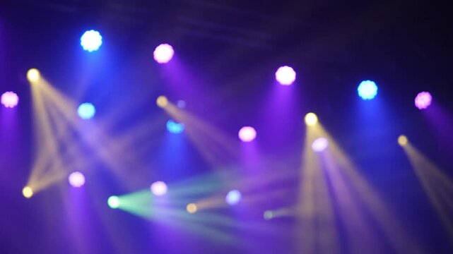 concert stage lights, purple and blue spotlights, yellow beams, bokeh effect, for background or overlay, nightclub or live music event