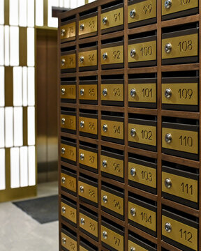 Rows of numbered postal mailboxes with metallic finish