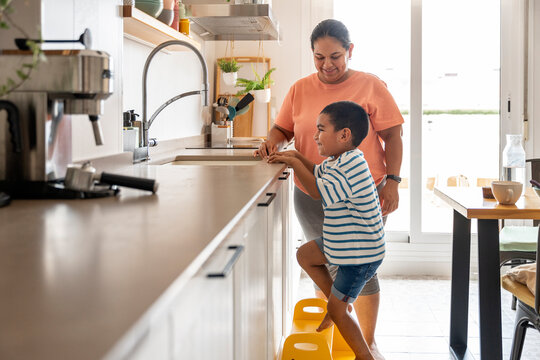 Mother and son enjoying time together in kitchen