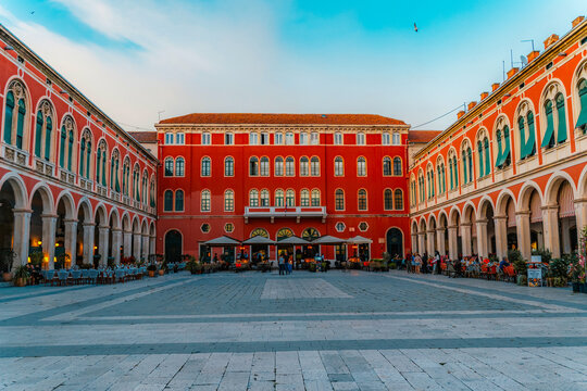 The iconic Republic Square (Prokurative) in Split, featuring stunning red neo-Renaissance architecture and grand arches, Dalmatia, Croatia.