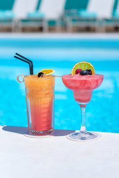 Frozen fruit cocktails resting by swimming pool