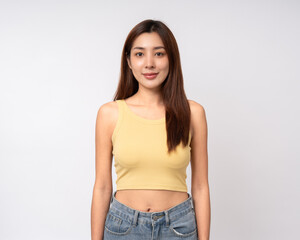 Beautiful smiling happy young asian woman in yellow shirt. Charming female lady standing pose on isolated white background. Asian woman people looking camera confident with backdrop.