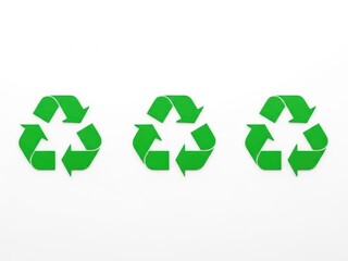 Obraz premium Three green recycling symbols on white background