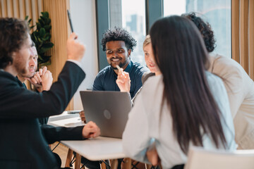 Creative business team meeting with professionals discussing project strategy, presenting ideas on...