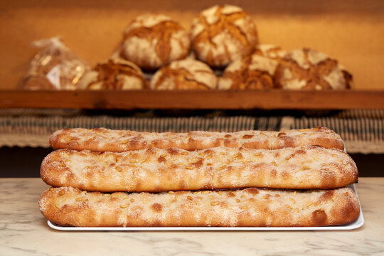 Artisanal coca de forner in a bakery setting