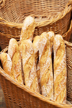 Fresh artisanal baguettes in wicker baskets