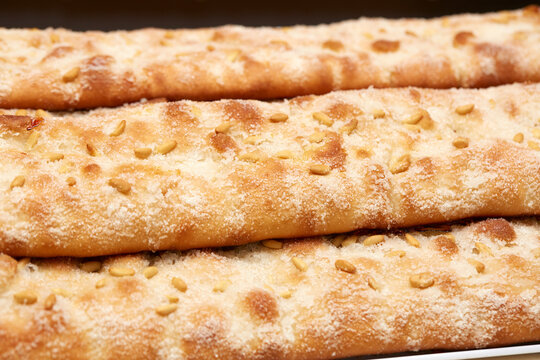 Coca de forner with sugar topping and pine nuts