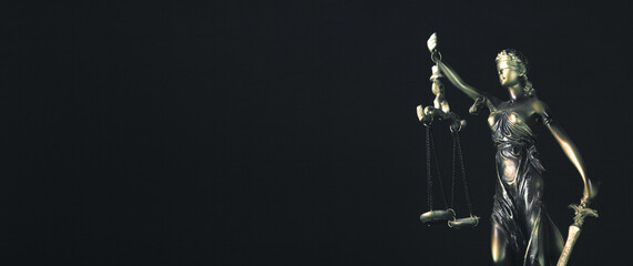 Legal law concept. Statue of justice with scales on black background.