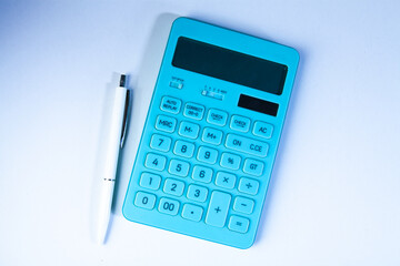 Calculator and pen on white background. Business and finance concept.
