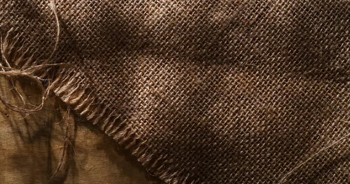 Slow Motion of Rustic Burlap Fabric Texture Close Up. Natural Linen Textile Background Concept Of Craft And Sustainability