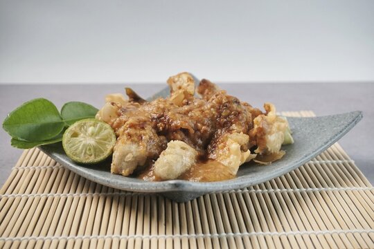 Batagor or baso Tahu Goreng. Indonesian Traditional Street Food Fried Dumpling Made from Fish with Tapioca Flour, Tofu, and Dumpling Wrapper. Served with Spicy Peanut Sauce, Sweet Soy Sauce, and Lime 
