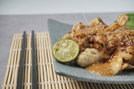 Batagor or baso Tahu Goreng. Indonesian Traditional Street Food Fried Dumpling Made from Fish with Tapioca Flour, Tofu, and Dumpling Wrapper. Served with Spicy Peanut Sauce, Sweet Soy Sauce, and Lime 