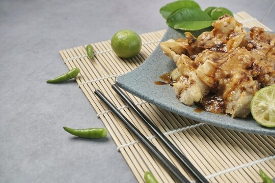 Batagor or baso Tahu Goreng. Indonesian Traditional Street Food Fried Dumpling Made from Fish with Tapioca Flour, Tofu, and Dumpling Wrapper. Served with Spicy Peanut Sauce, Sweet Soy Sauce, and Lime 