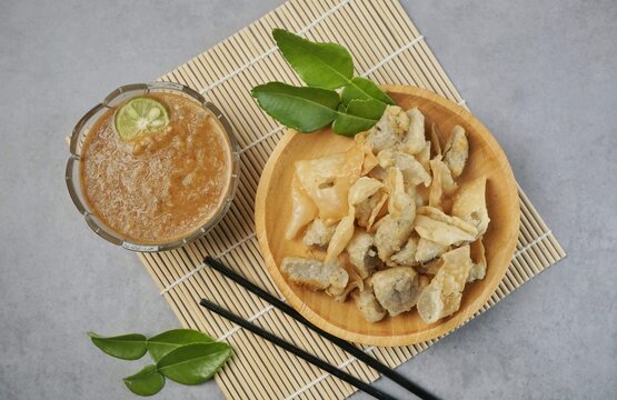 Batagor or baso Tahu Goreng. Indonesian Traditional Street Food Fried Dumpling Made from Fish with Tapioca Flour, Tofu, and Dumpling Wrapper. Served with Spicy Peanut Sauce, Sweet Soy Sauce, and Lime 