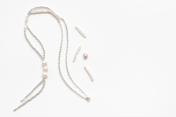 Making a pearls necklace. Precious pearls necklace beads with silver for jewelry, top view