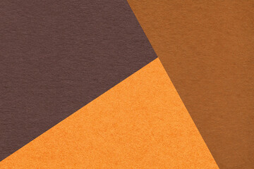 Fototapeta premium Geometric triangular dark brown orange rust textured paper background with copy space for banner template