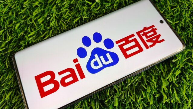 Baidu logo on smartphone screen on green grass background