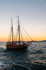 Fototapeta premium Luxury private yacht boat sail at Croatian bay harbor shore clear water withsunset . Boat vessel charter service