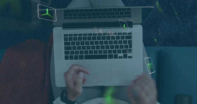 Man rotating phone, lowering phone and typing on laptop keys while floating green UI guiding tech
