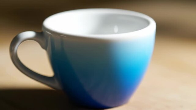 A white ceramic mug slowly changes color to blue. The vibrant blue gradient rises from the bottom.