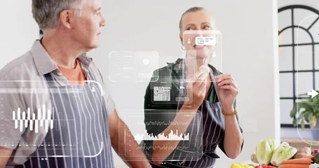 Fotobehang Koken Preparing senior couple in striped aprons tasting produce at bright kitchen, with digital overlay  © vectorfusionart