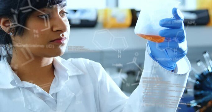 Lab pro raising beaker to light, rotating and testing orange sample while formulas overlaying face