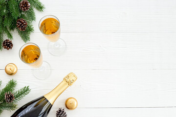 Christmas fir tree branch with champagne bottle and decoration, top view. Happy New Year greeting card