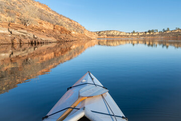 Horsetooth Reservoir at foothills of Rocky Mountains in northern Colorado - POV from expedtion canoe in warm winter scenery