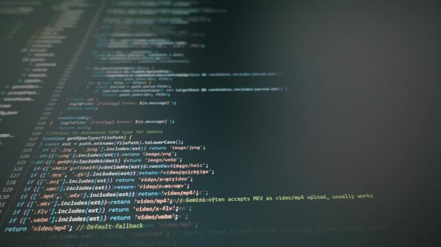 Close-up of colorful JavaScript code scrolling on a dark monitor. Concept of vibe coding, AI assisted application development, and modern software engineering.