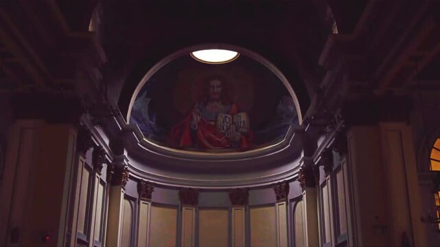 Low Angle View of Jesus Christ Mural in Church Apse with Dramatic Lighting, Sacred Religious Art of Christ Pantocrator on Cathedral Dome Ceiling