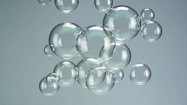 Clear Soap Bubbles Floating Against A Soft Grey Background water liquid