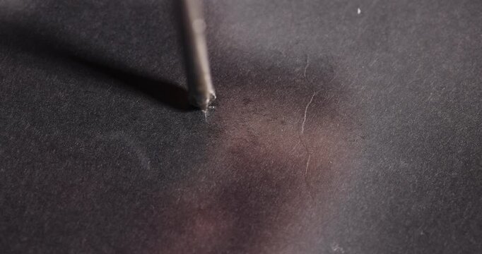 old strong glass on a black uneven background, the glass is strong but with scuffs and minor defects