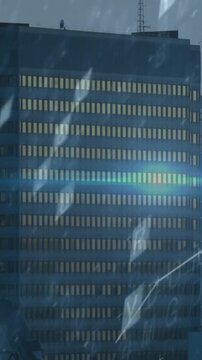 Vertical video: Camera panning right, tower dominating, graph tracing data, rain revealing skyline
