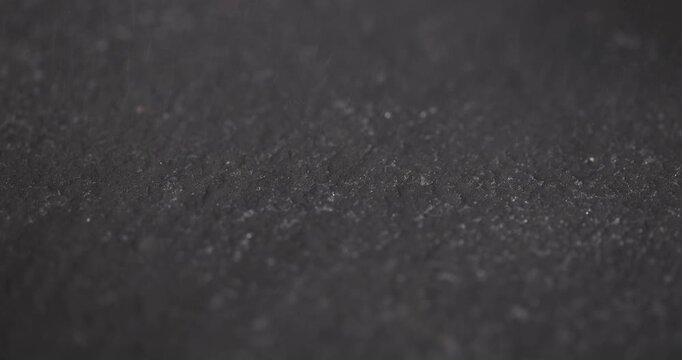 slate for serving, covered with lots of water drops kitchen board made of black embossed slate