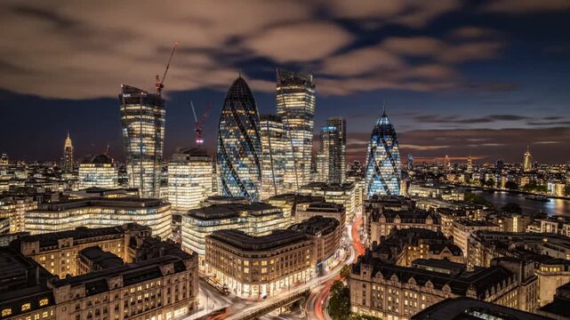 City skyline at sunset with buildings and river in view from high ground in London