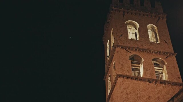 The Torre del Popolo illuminated in the dark. Assisi, Italy.
