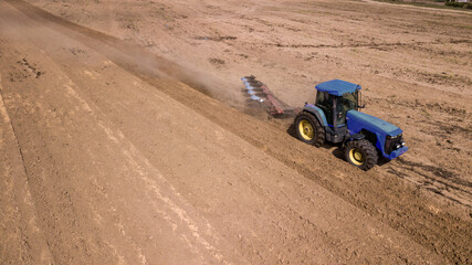 tractor plowing field top view, aerial photography with drone