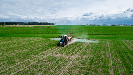Fototapeta premium Aerial view, Tractor spraying pesticides at soy bean fields
