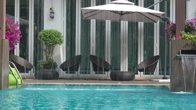 Hotel swimming pool waterfall spa relaxation slow motion