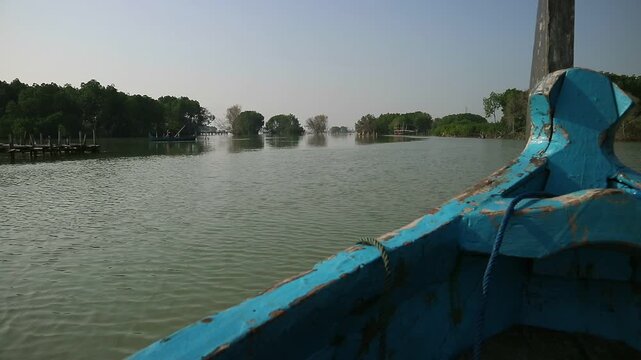 a pilgrimage to the Bedono village area, Demak, Central Java, Indonesia, which is now submerged due to land subsidence with only the remaining mangrove forests.