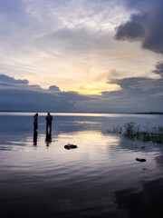 Fototapeta premium Two couple chilling on river side at the time sunset.