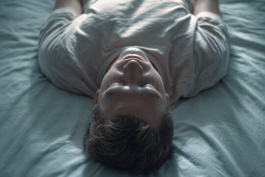 Elderly grandfather meditating on pastel watercolor paper, top-down flat lay with symmetric composition, soft silk texture, commercial clean style