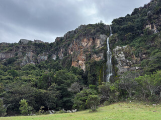  Beautiful waterfall cascading over a rocky cliff in a lush green forest - Cascada del Vino, Lara, Venezuela