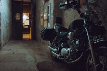 A large motor parked in the passage of an old building